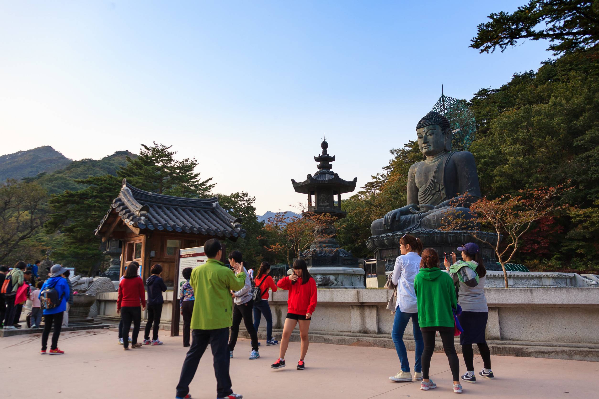 Mt Seorak In Autumn People Taking Pictures In Front Of Statue Of Buddha